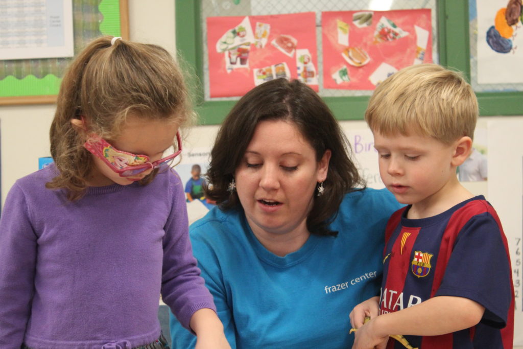 Caitlin Macon with two pre-k students
