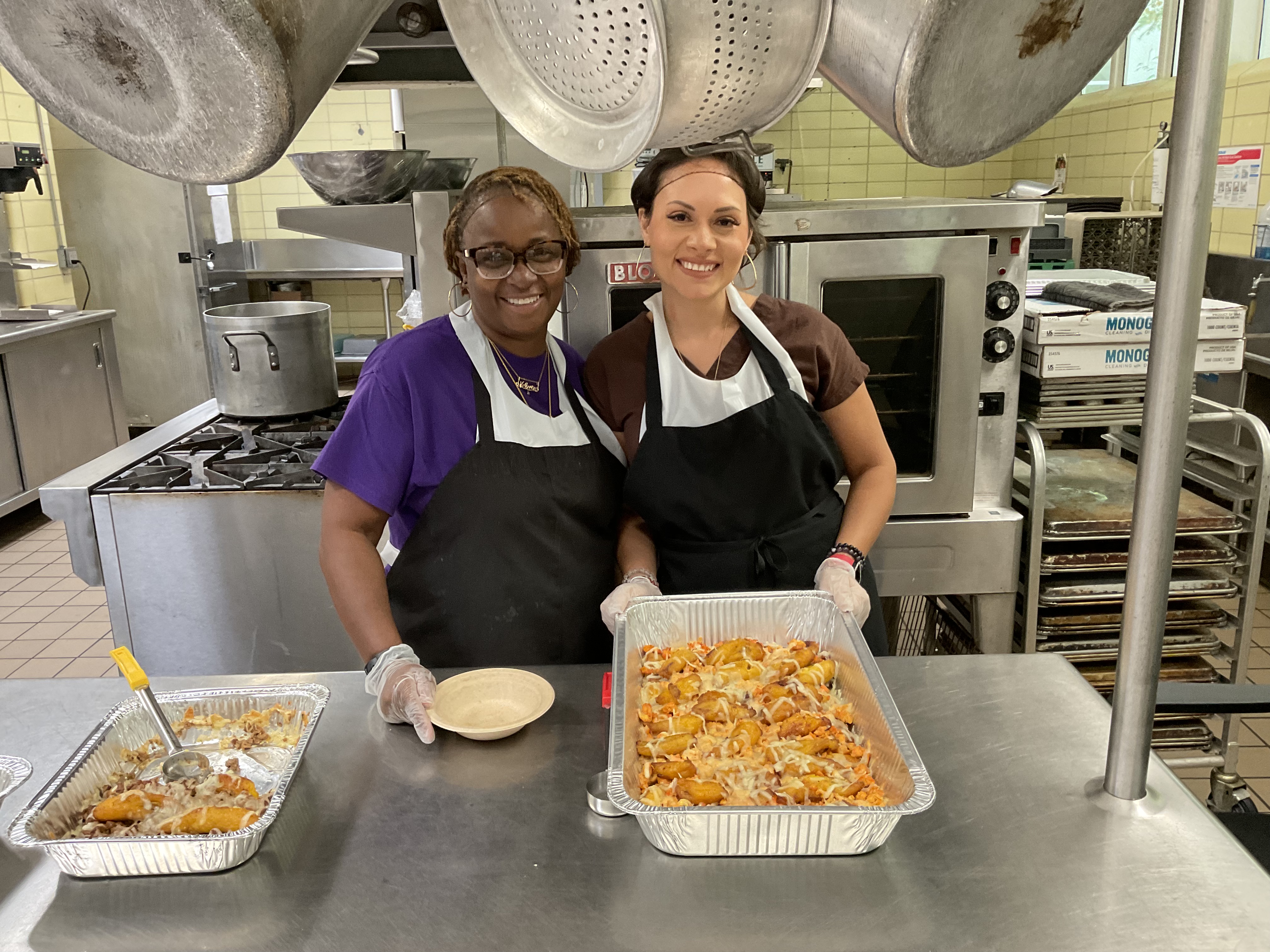 Ashley and Kitchen Coordinator Velecia Wright with their Pastelón
