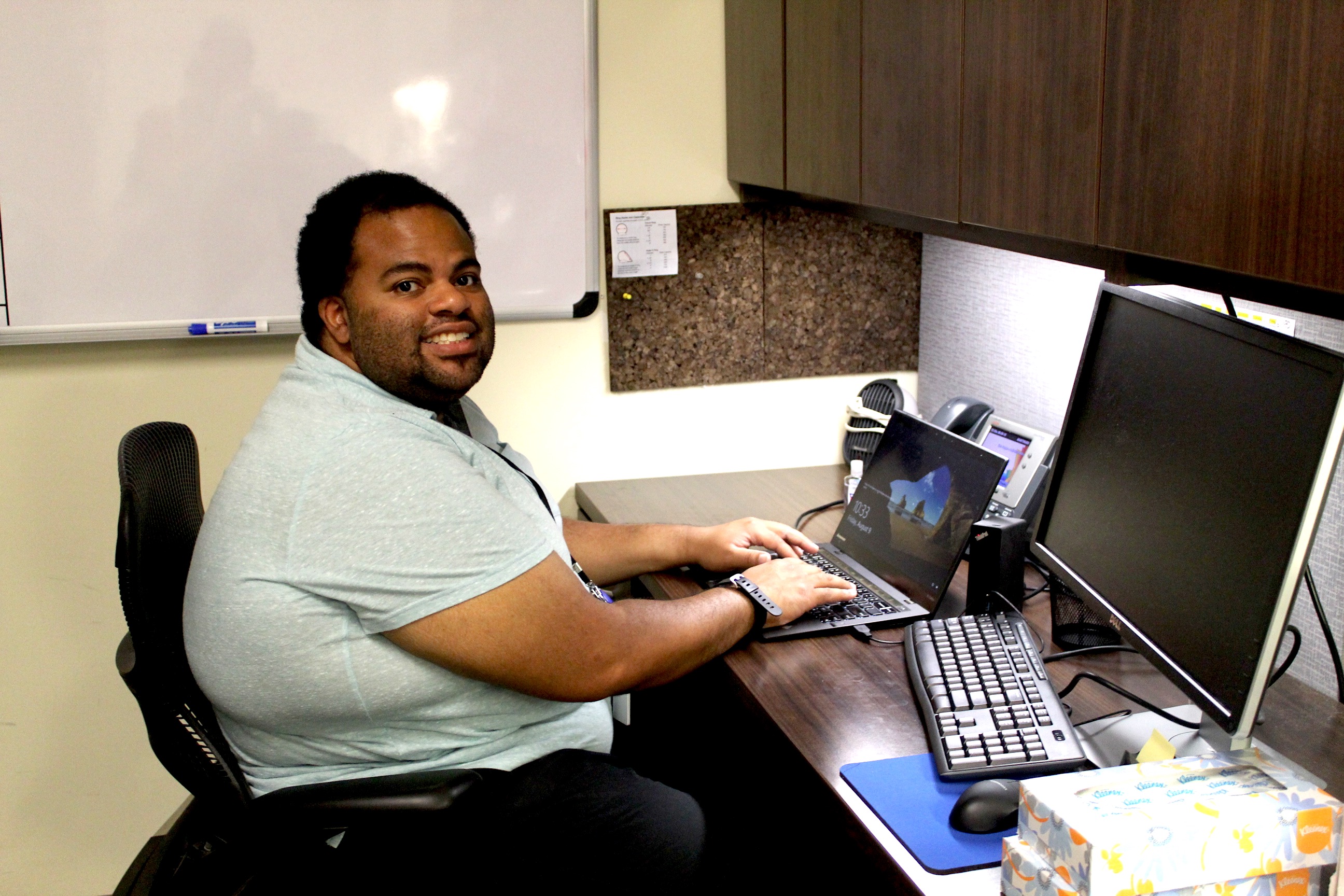 Drew has his own desk and computer.