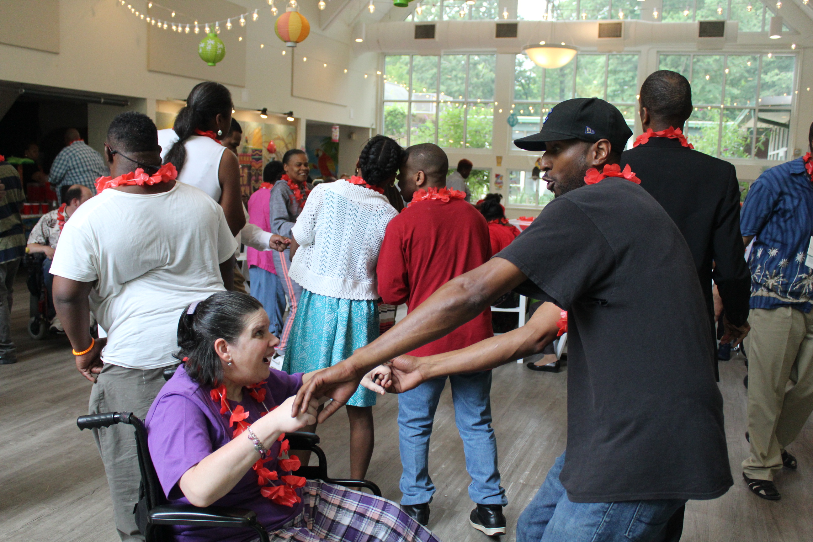 Eric and Adult Program participants enjoying a recent luau dance party