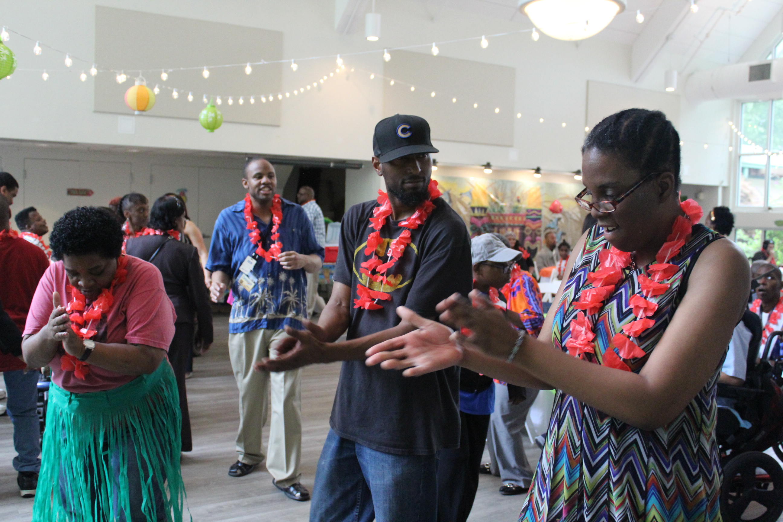 Eric and Adult Program participants enjoying a recent luau dance party