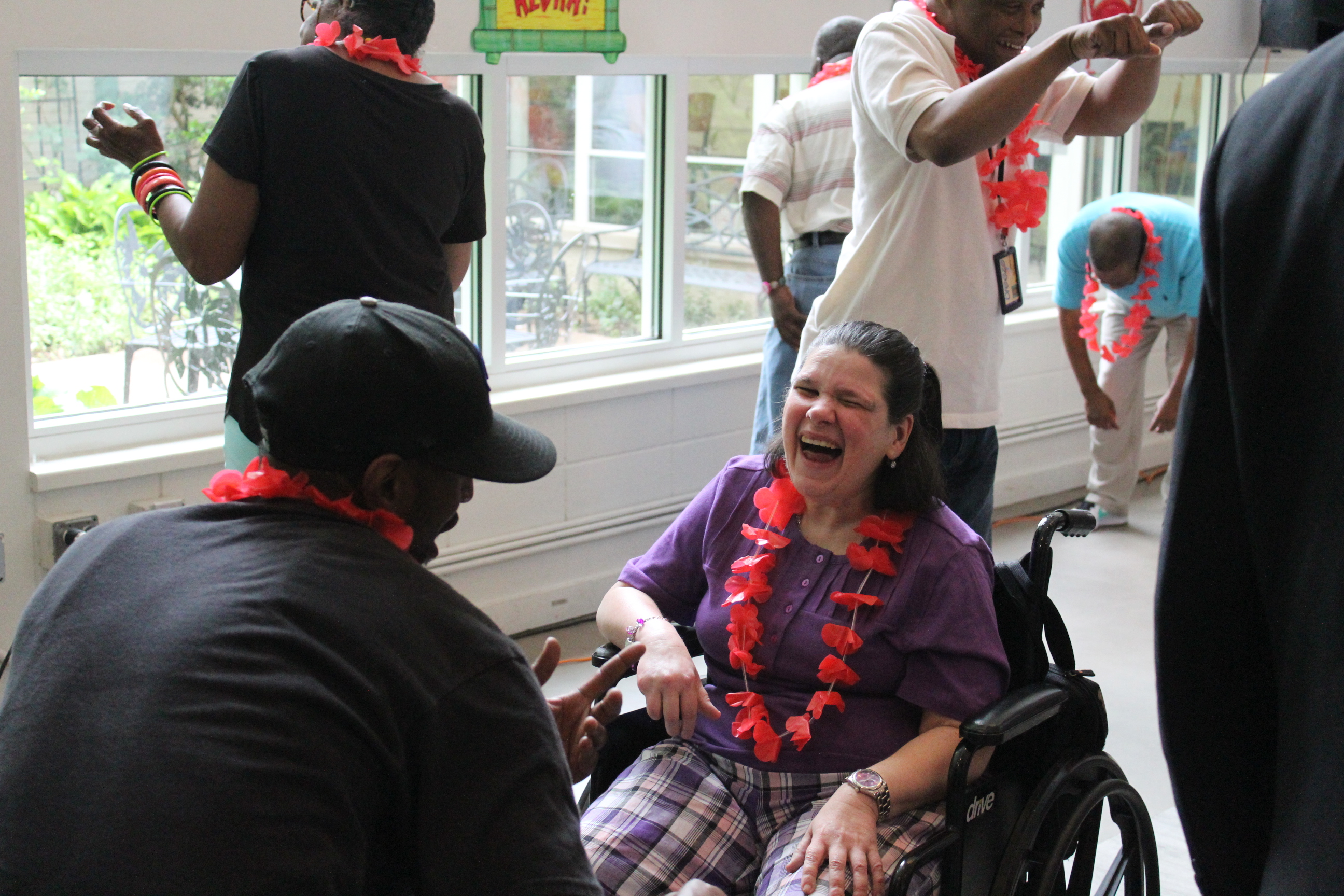 Eric and Adult Program participants enjoying a recent luau dance party