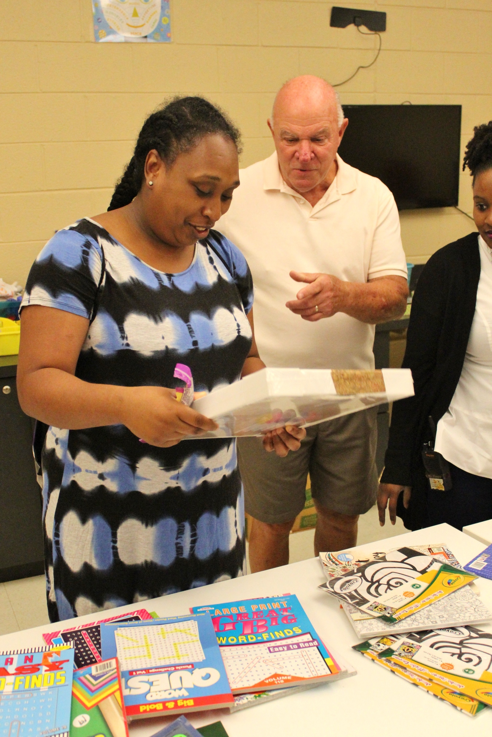 Meshelle is excited to see the new art supplies and puzzles that George brought.