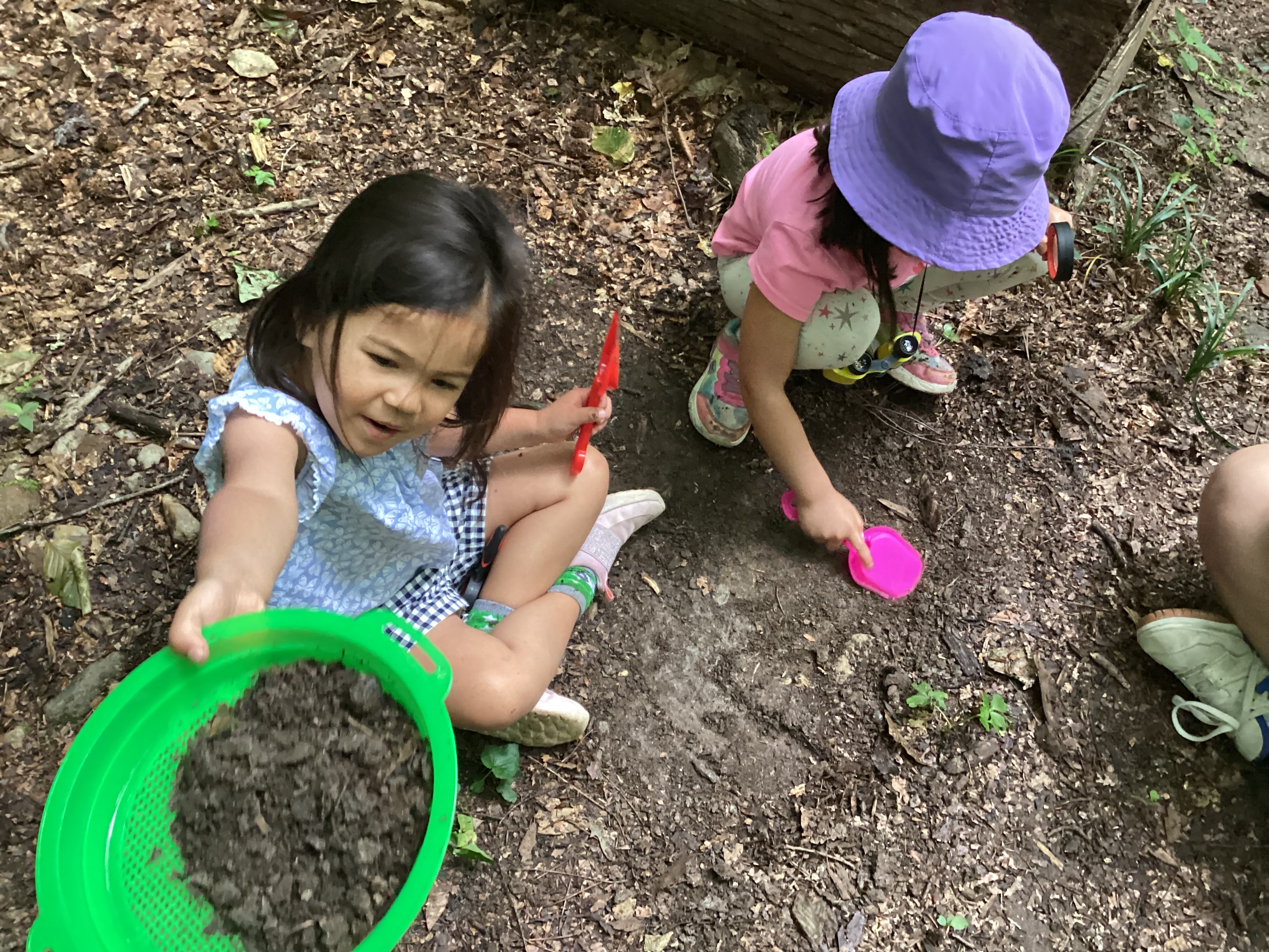 Campers discovering and sifting through different types of soil.