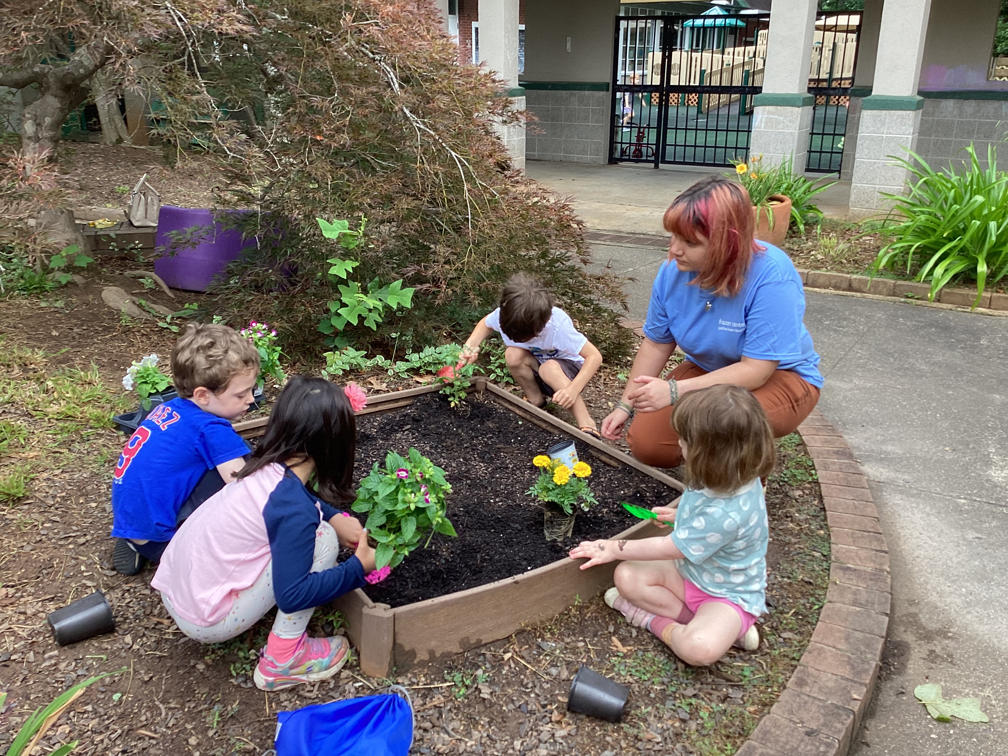 Summer Camp 2023: Planting flowers in the courtyard garden.