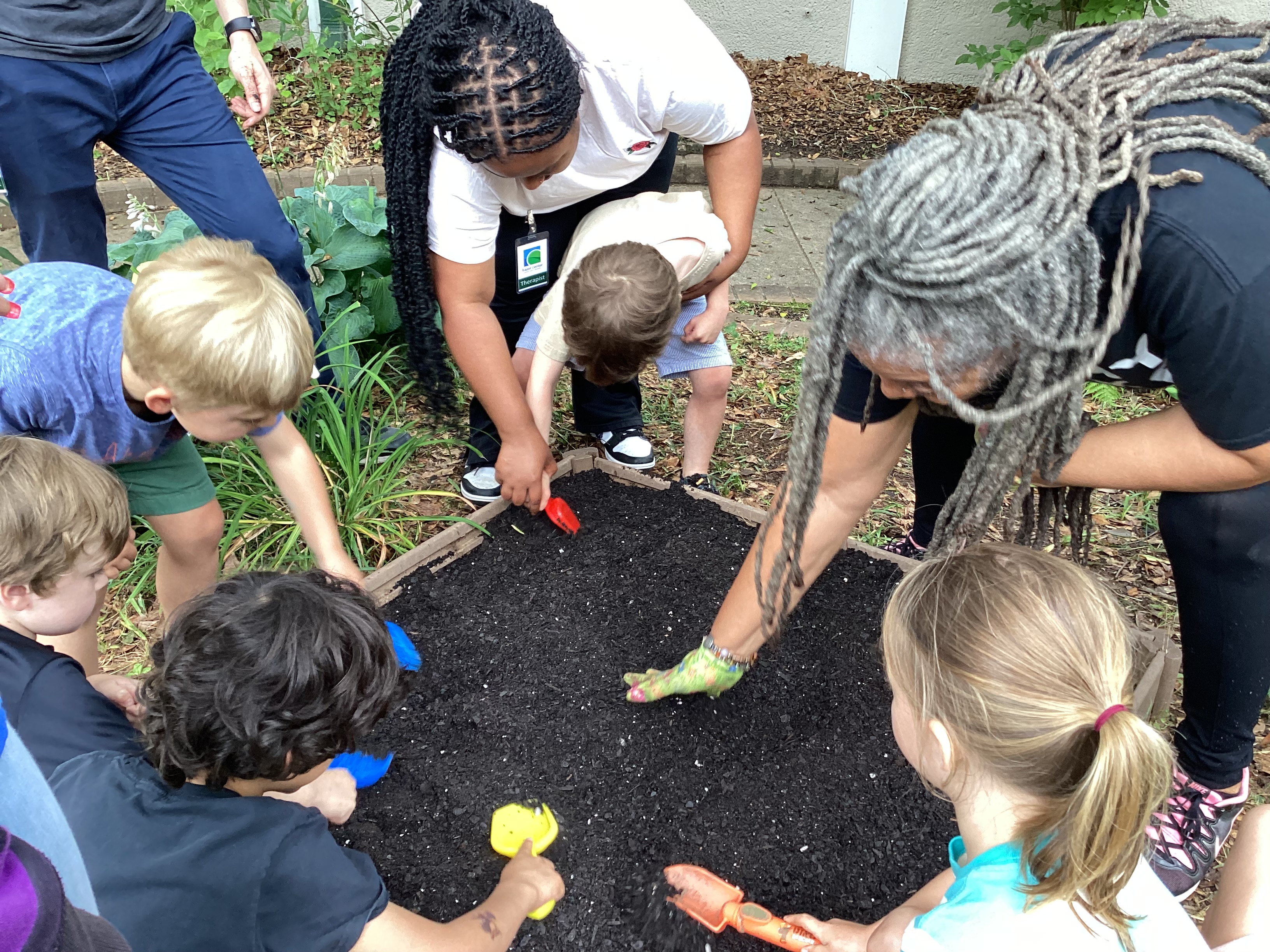 Summer Camp 2023: Prepping a garden bed in the courtyard.