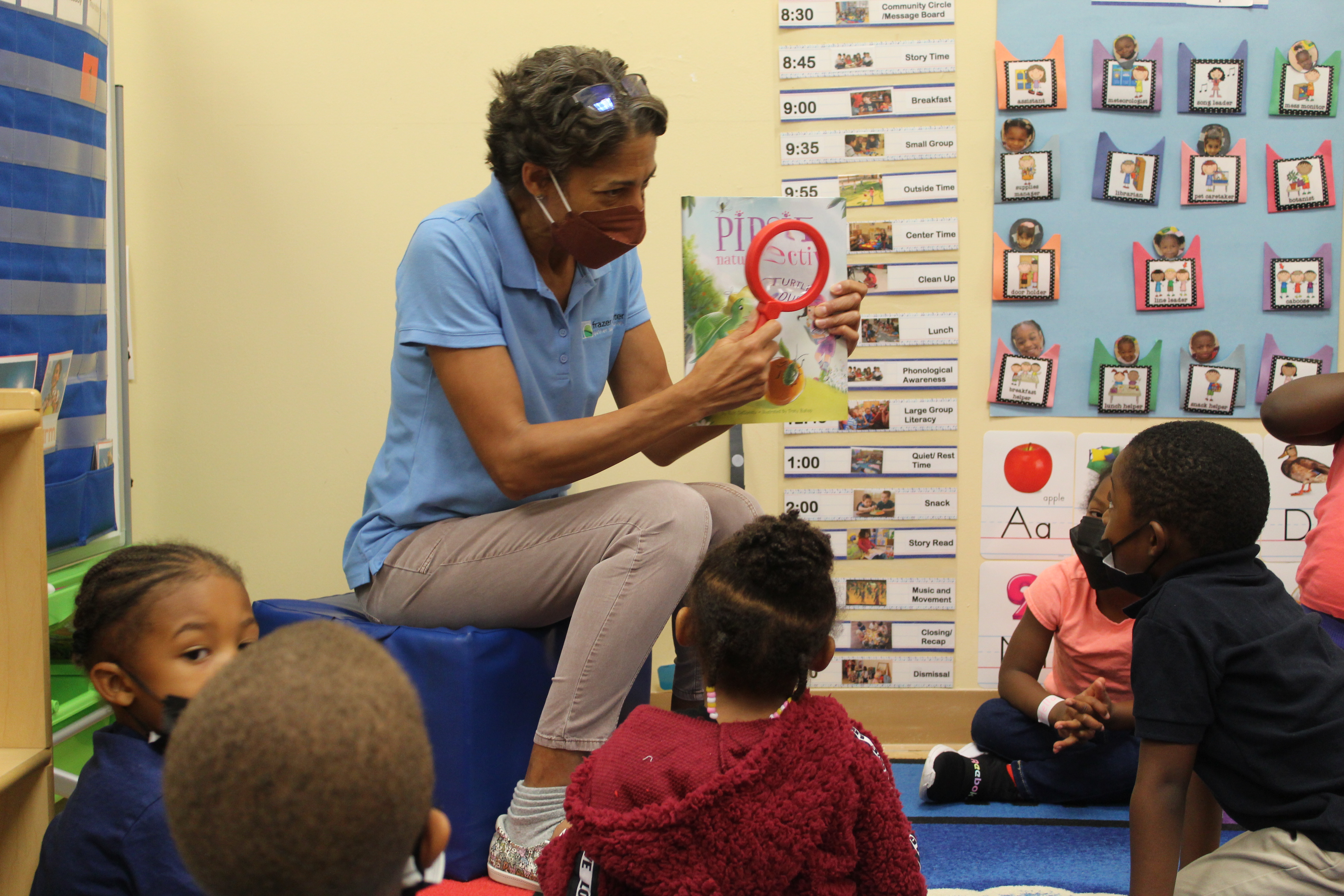 Frazer's Ms Kim begins by reading Pipsie: Nature Detective to the Our House children.