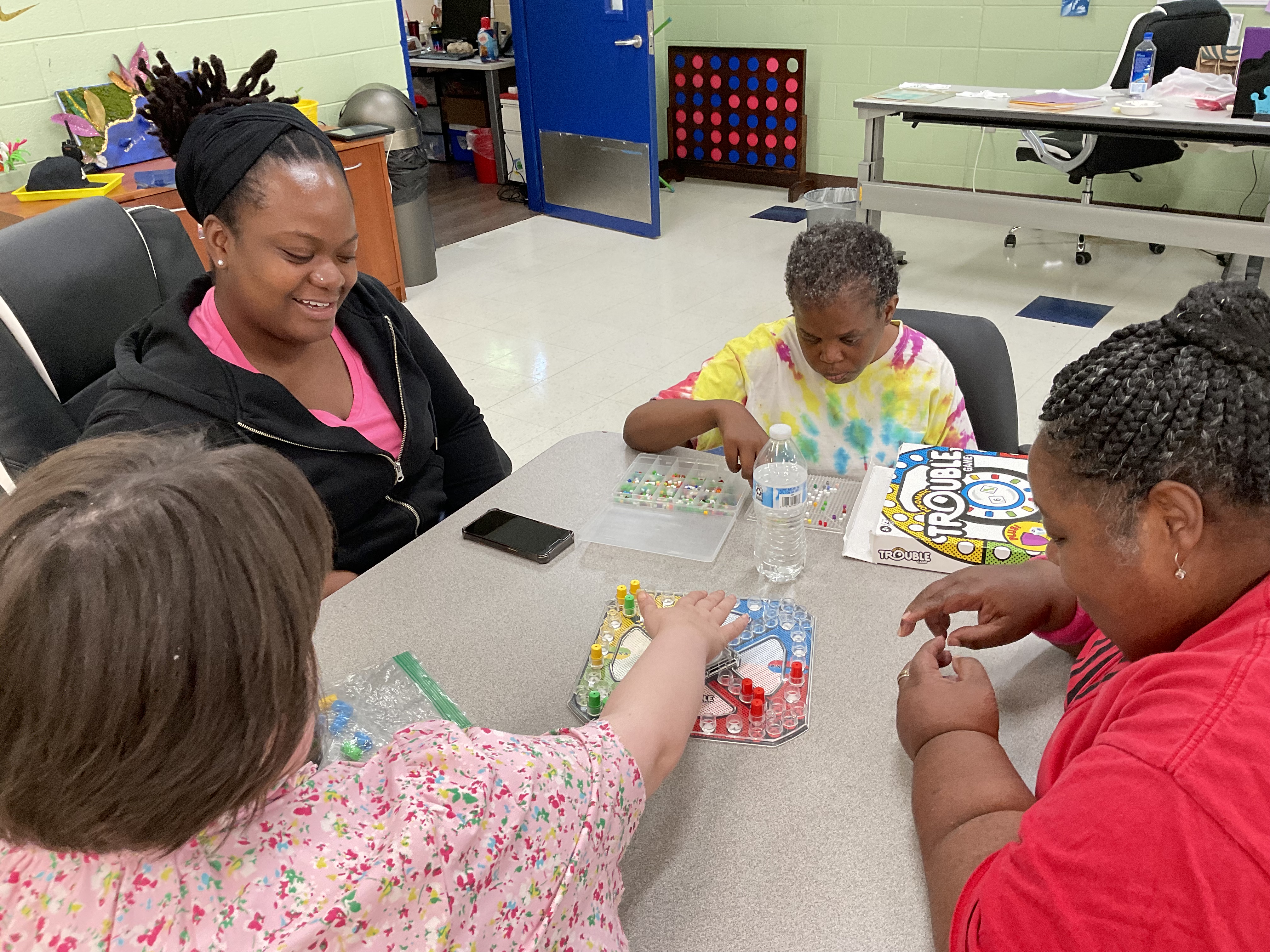 DSP Ifrika (L) getting into some good Trouble (games) with our adult participants.