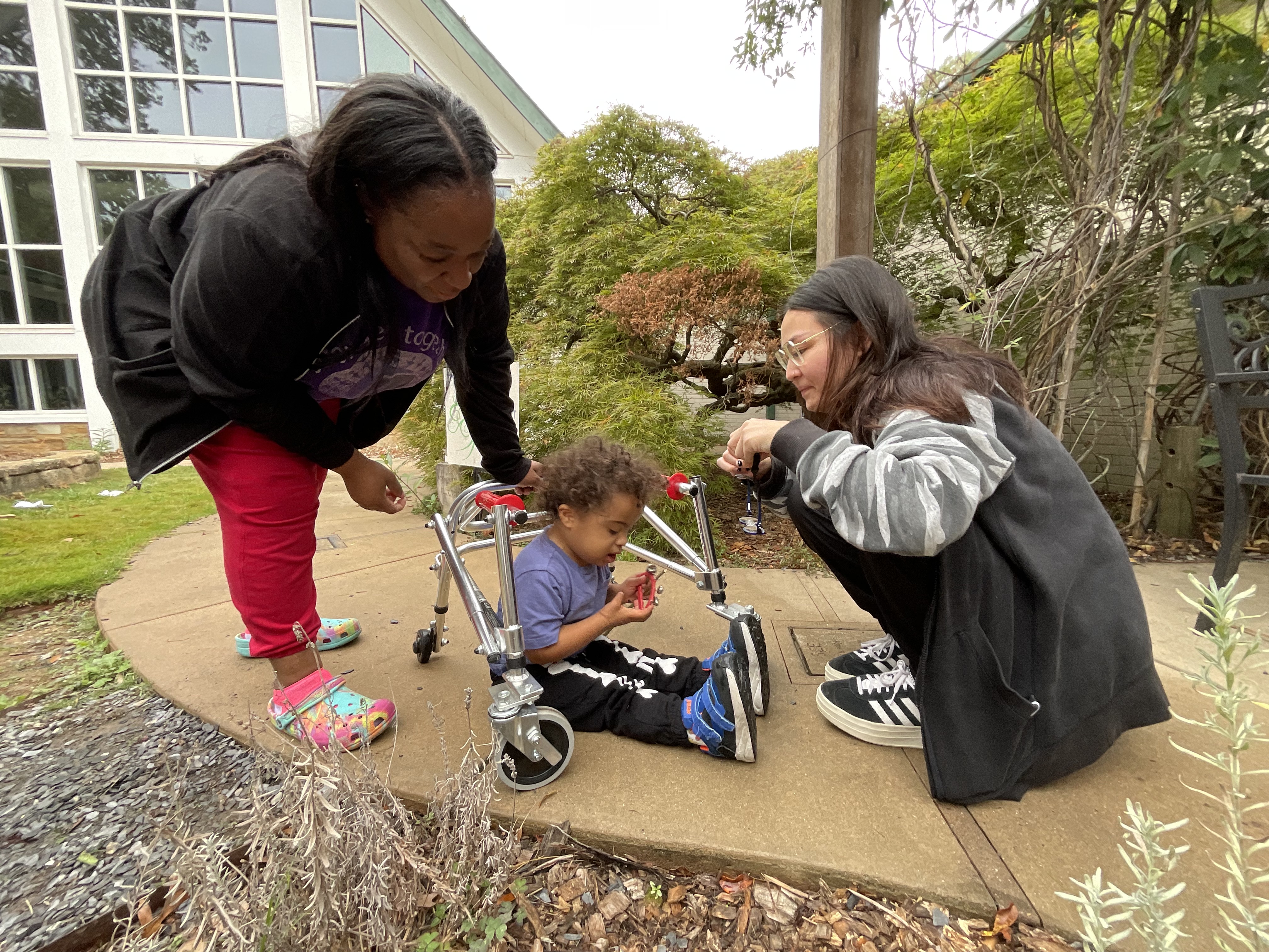 Khalil with his teacher, Tamica (L), and therapist, Debbie (R)