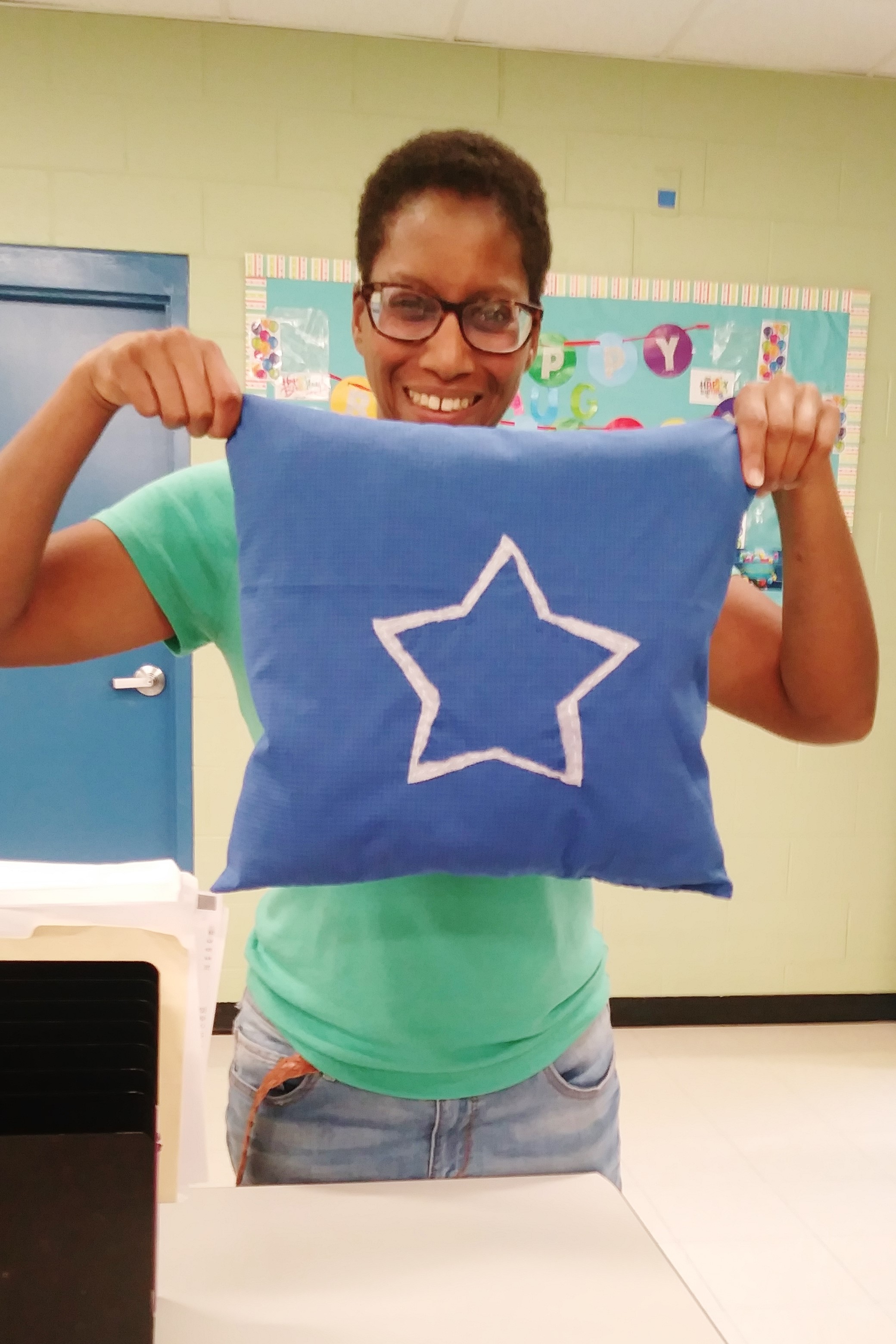 Kim showing off the Dallas Cowboys pillow that June helped her make