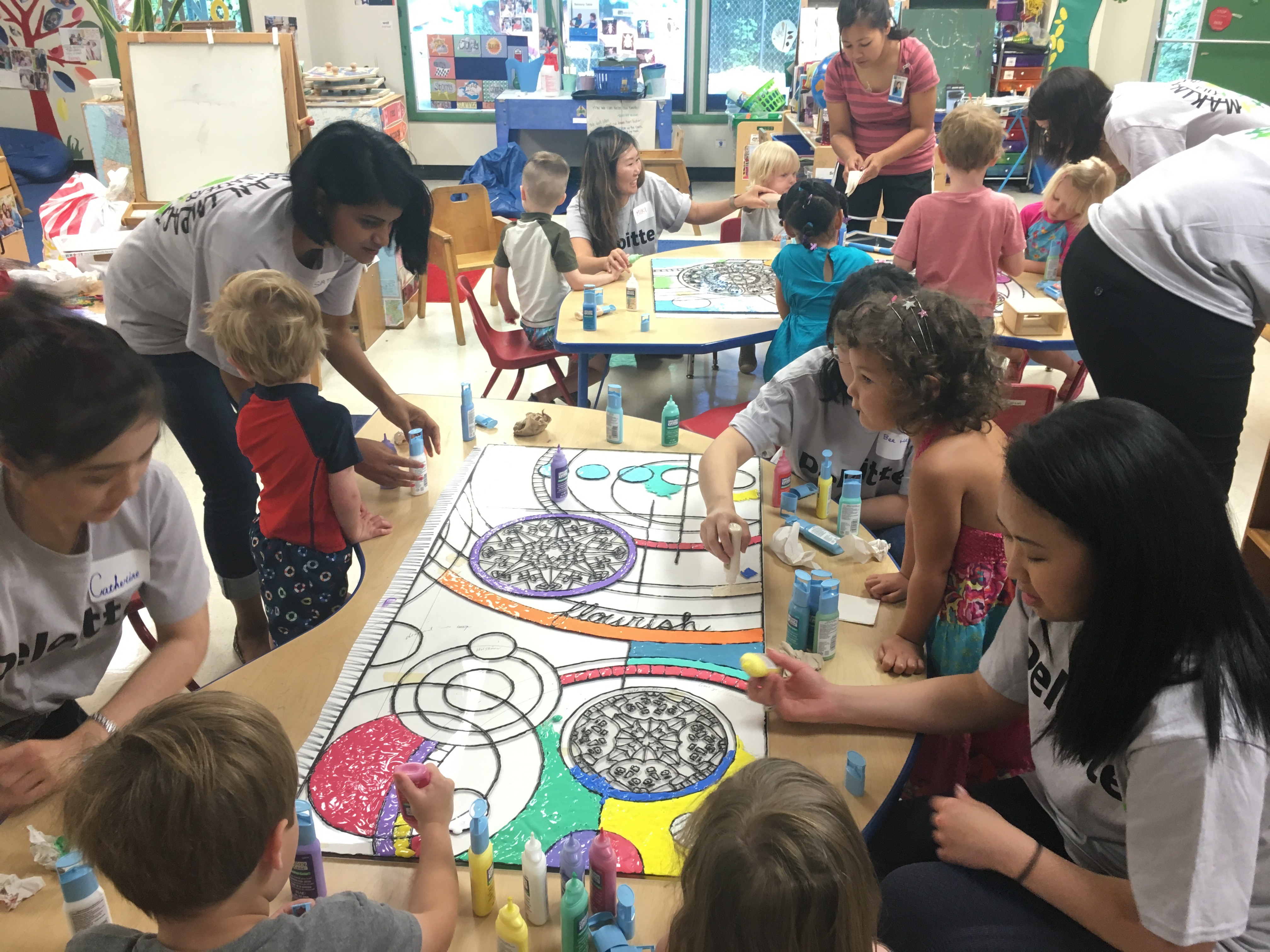 Volunteers from Deloitte working with the Pre-K students