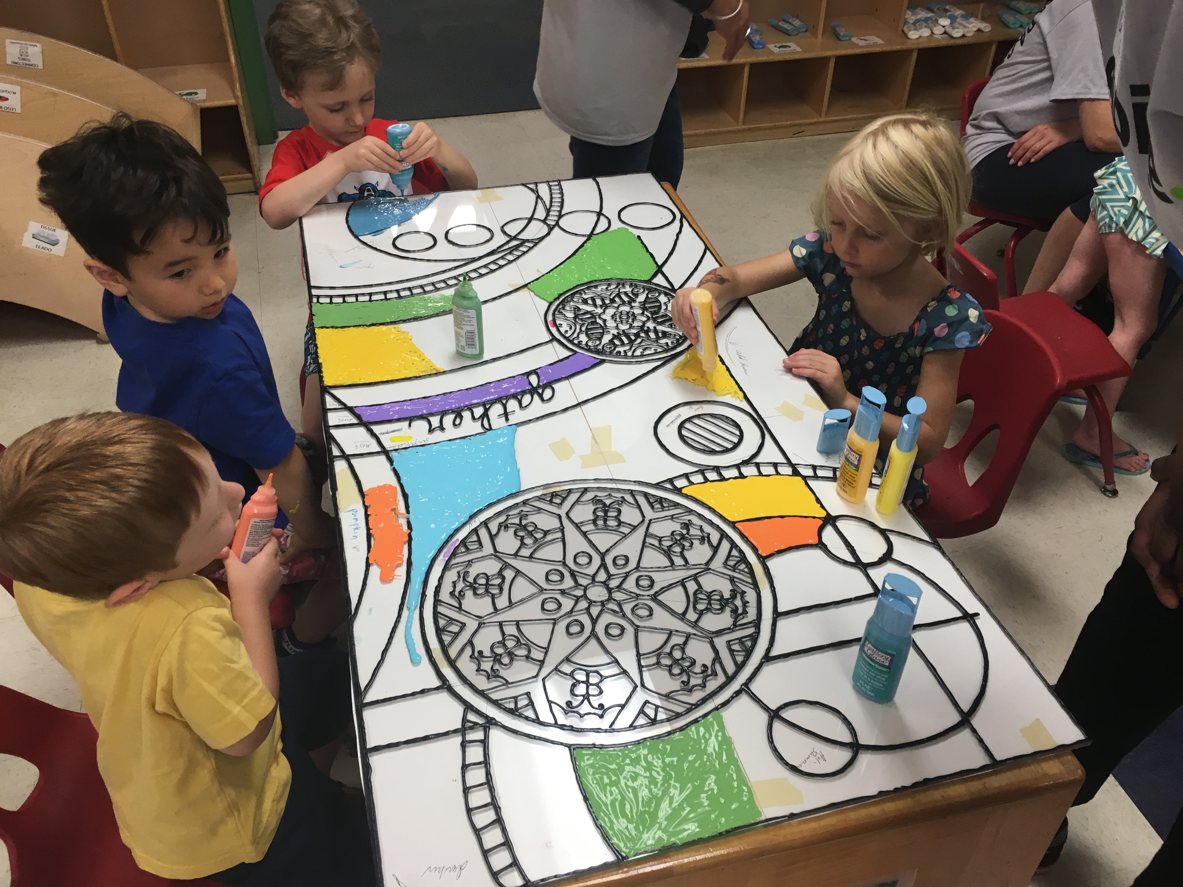 Pre-K students helping with the new art