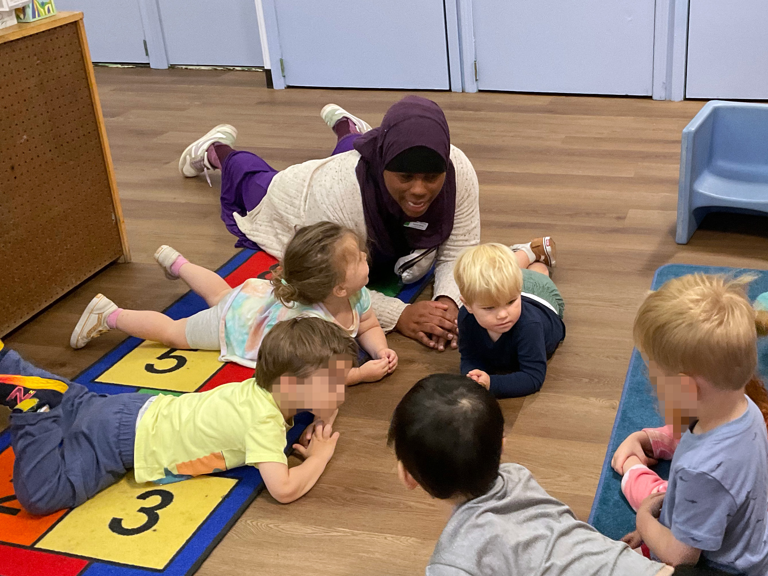 Hanging out on the floor with the children is one of Sahirah's favorite ways to engage.