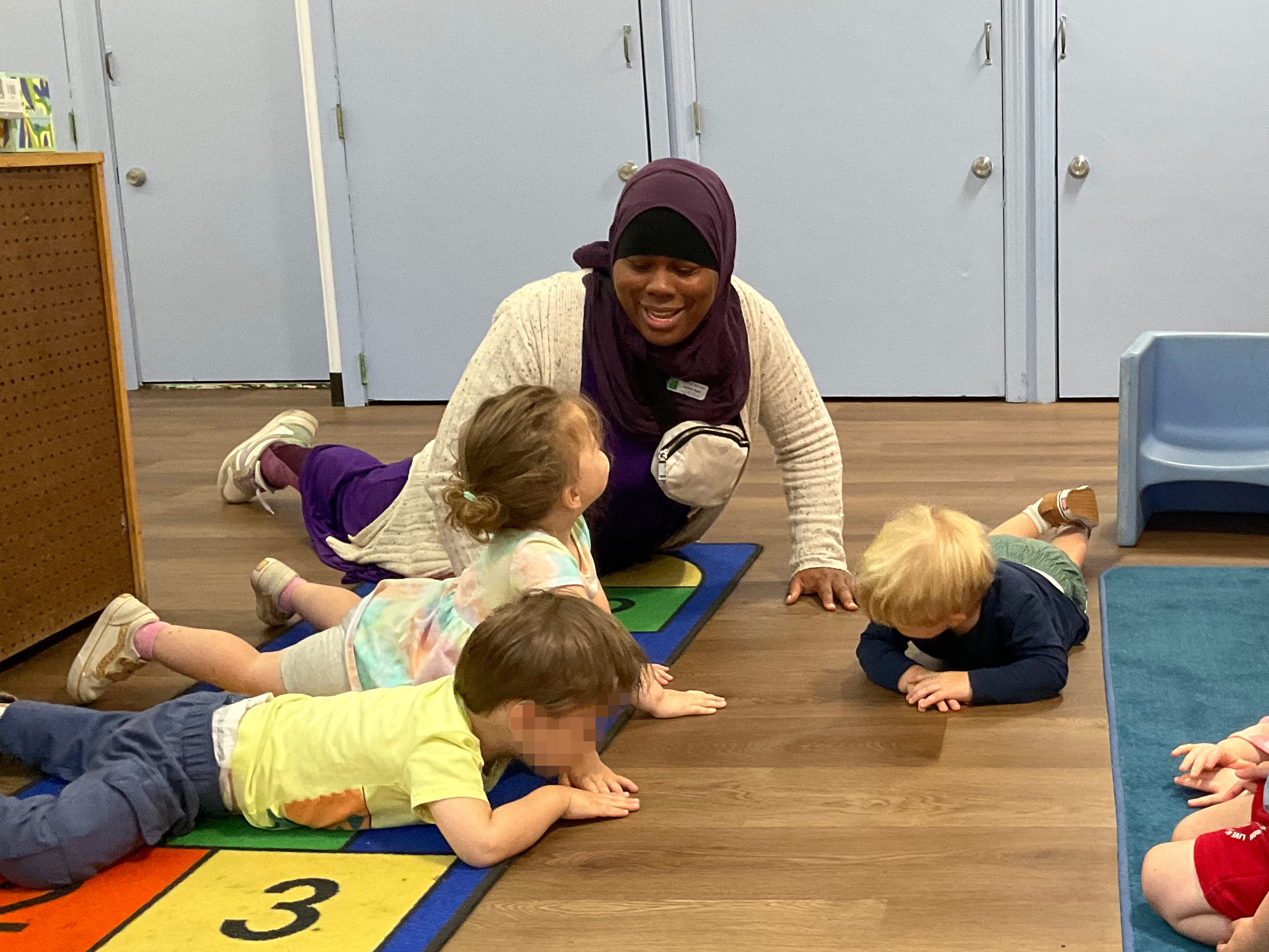 Sahirah teaching some yoga poses to help the children regulate their feelings