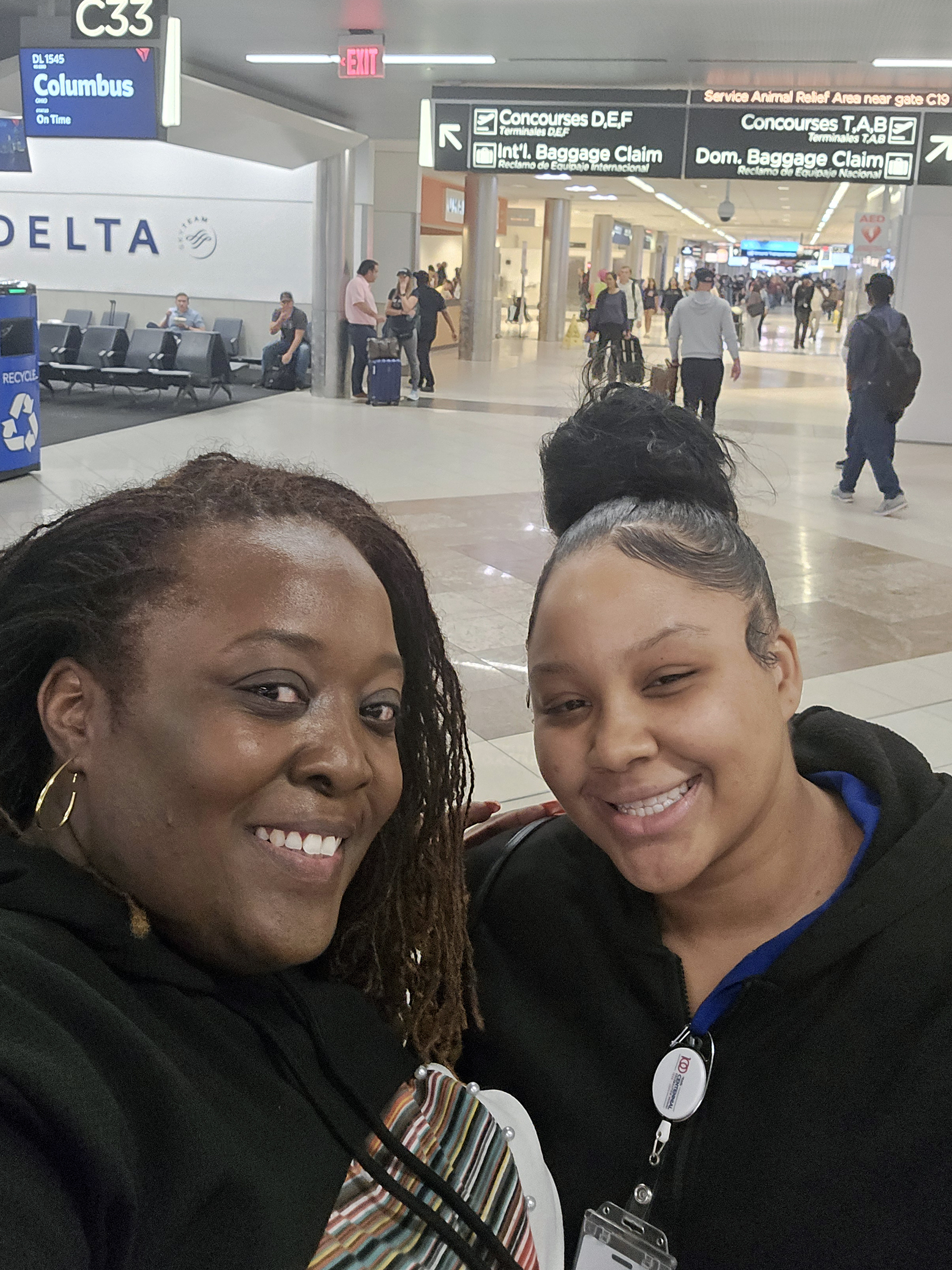 Aaliyah on the job at Hartsfield International Airport, with Frazer's Director of Adult Programs, Unondus Walker