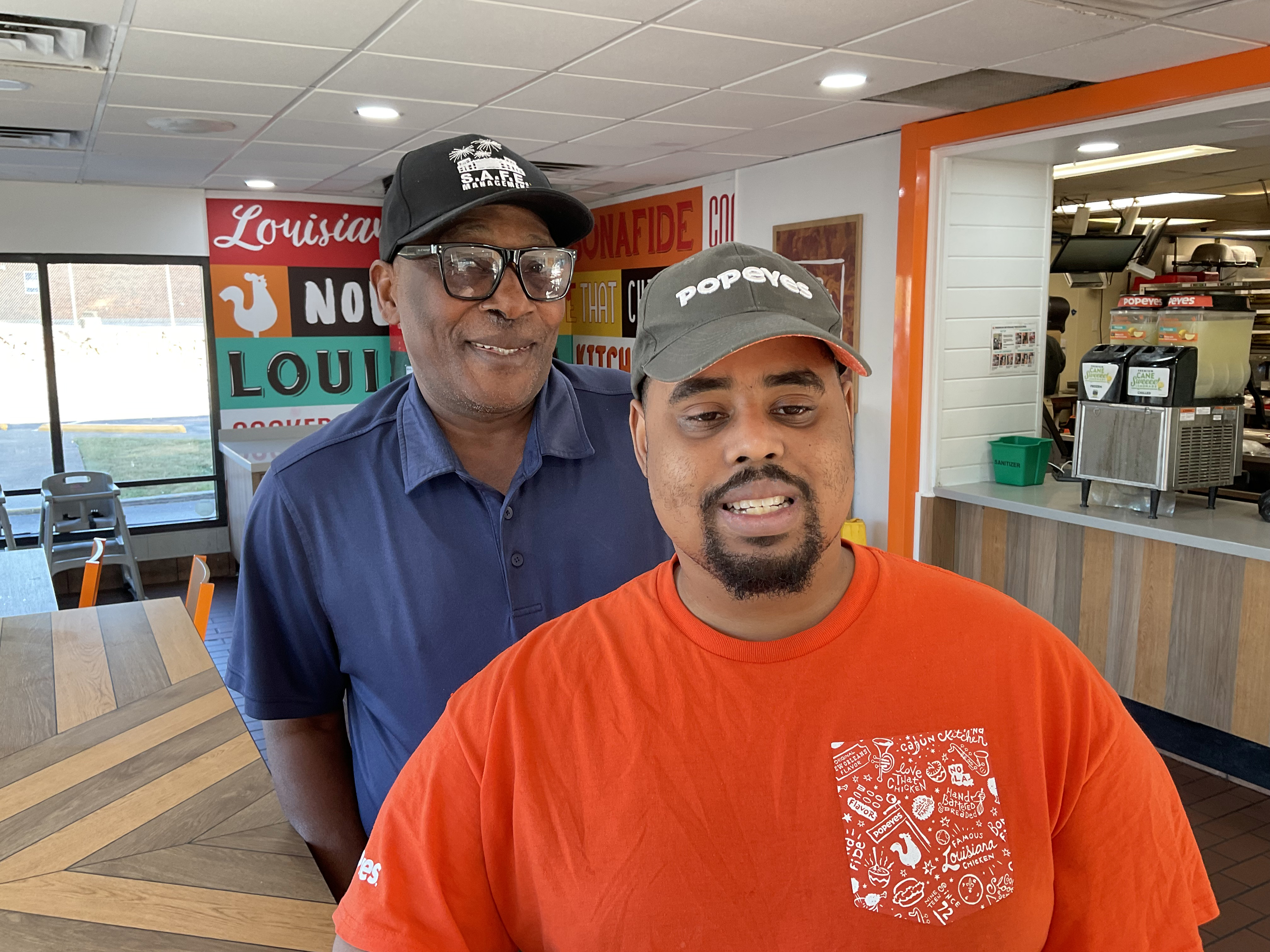 Matthew, a Frazer Center Supported Employment program participant, on the job at Popeyes, with Job Coach Thomas Johnson